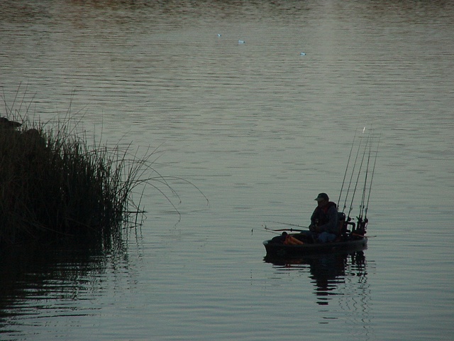 A moody backlit picture of a fisherman